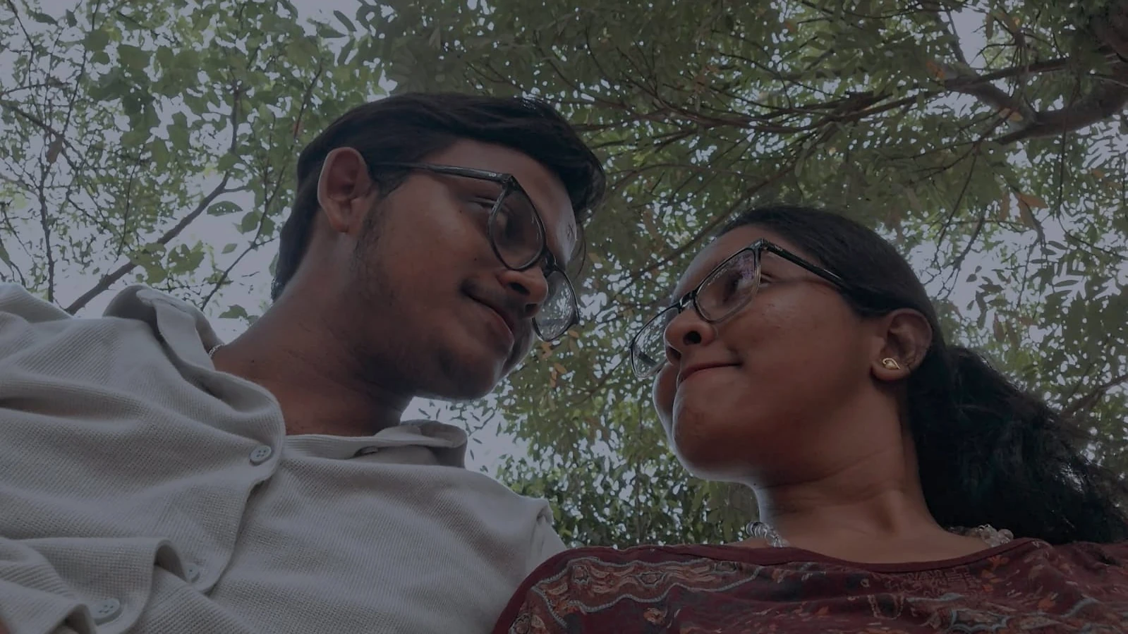 Sharing a smile beneath the tree canopy